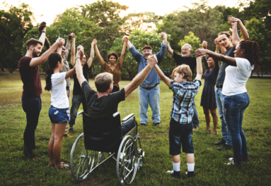 Group of people holding hand together in the park