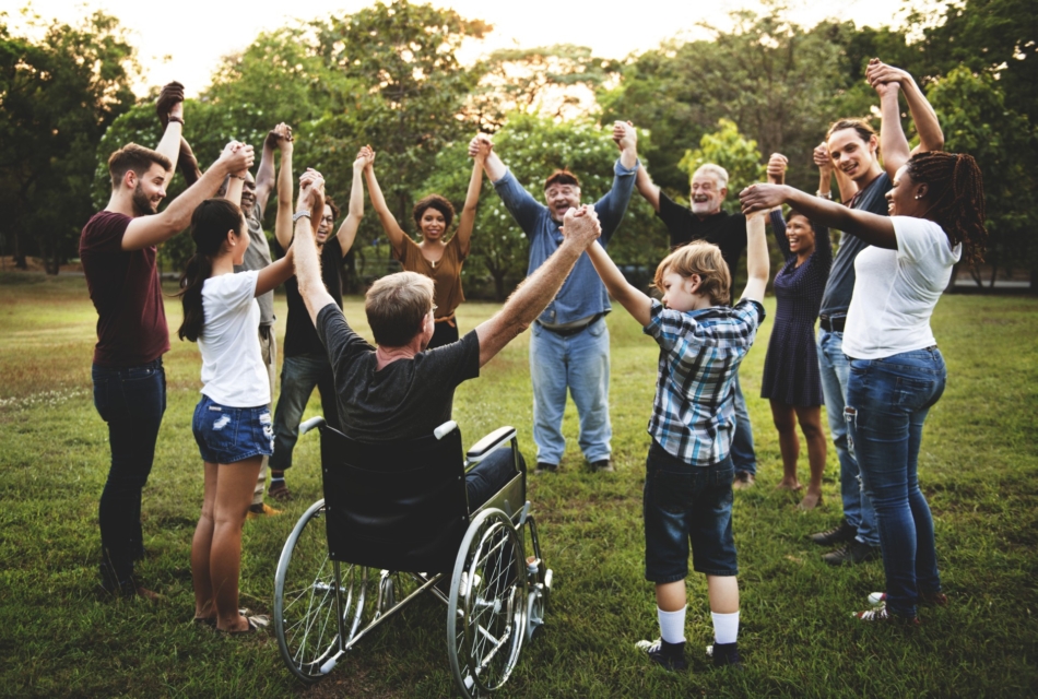 group of adults and kids in a circle, holding hands